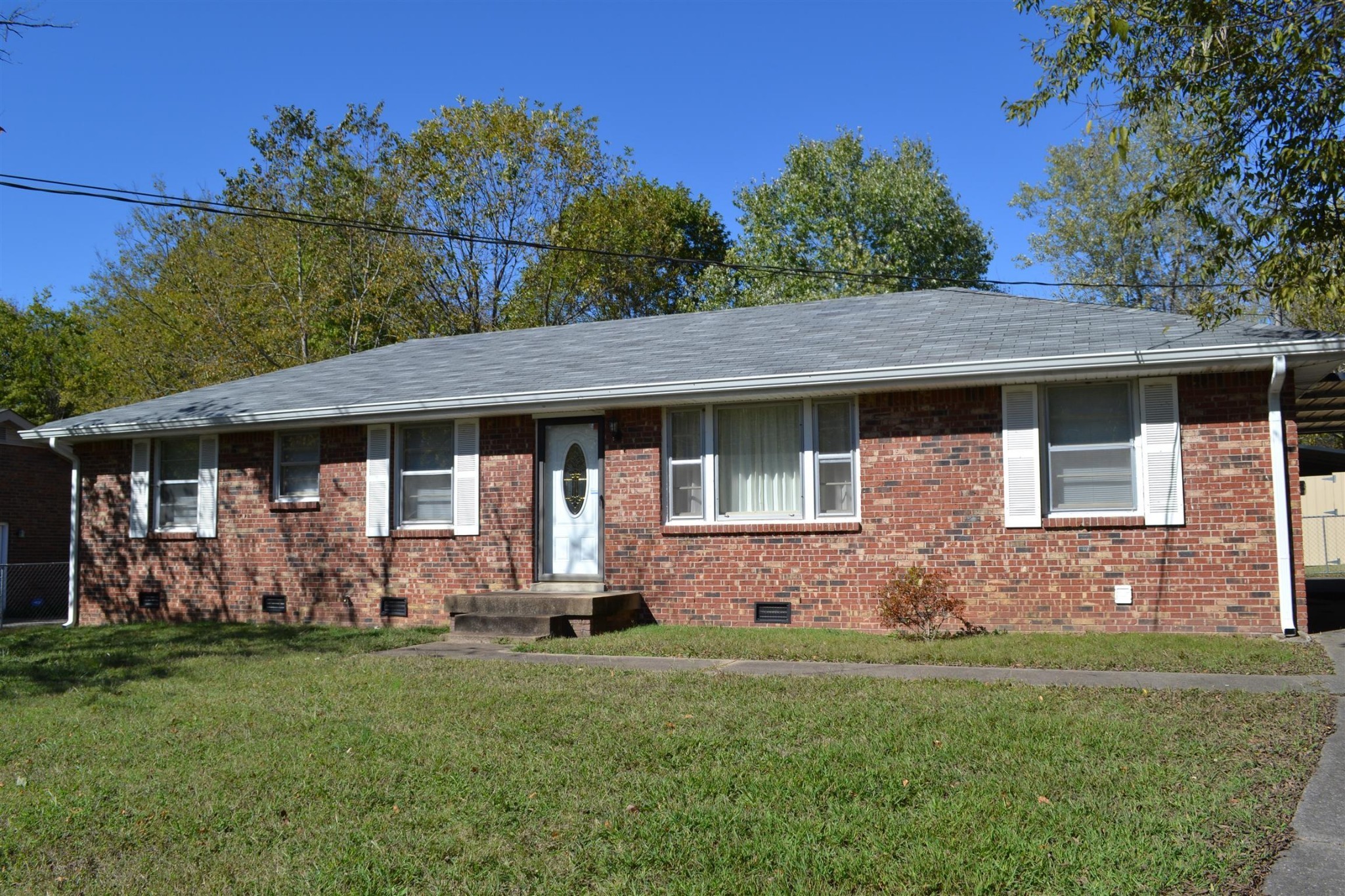 a front view of house with yard and outdoor seating