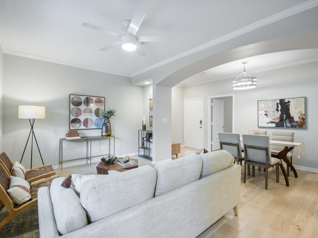 a living room with furniture and a dining table