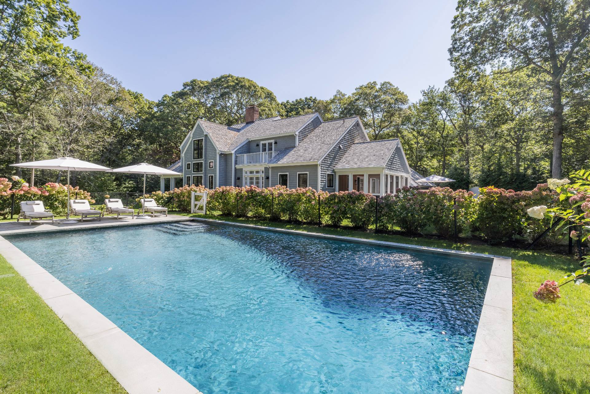 a view of a house with pool yard and lake view