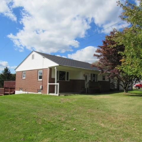 a front view of house with yard and green space