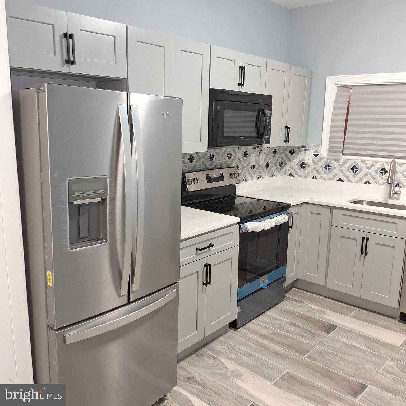 a kitchen with a refrigerator sink and microwave