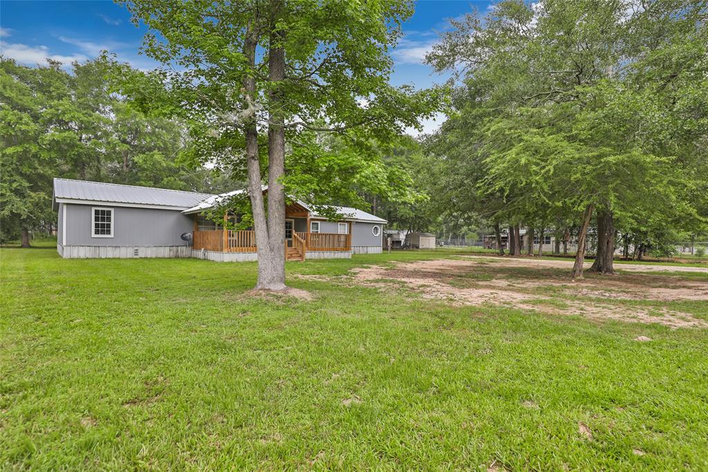 a front view of a house with yard and green space