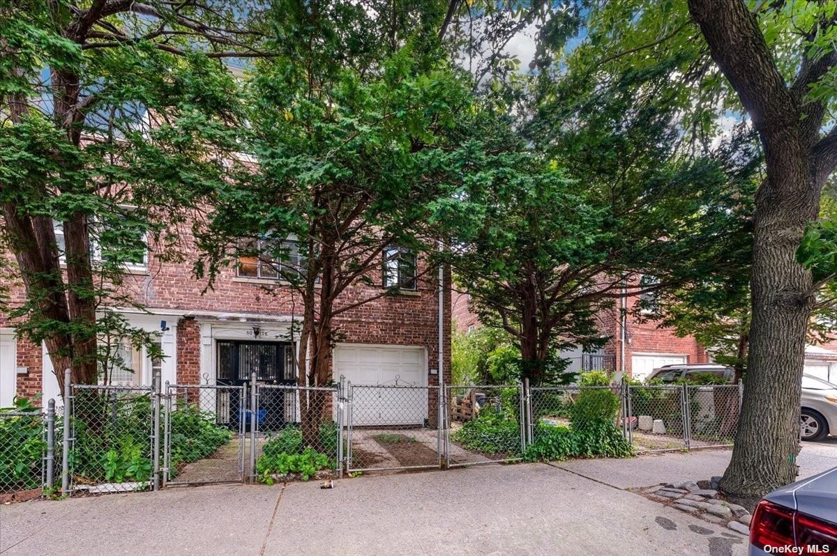 front view of a house with a tree