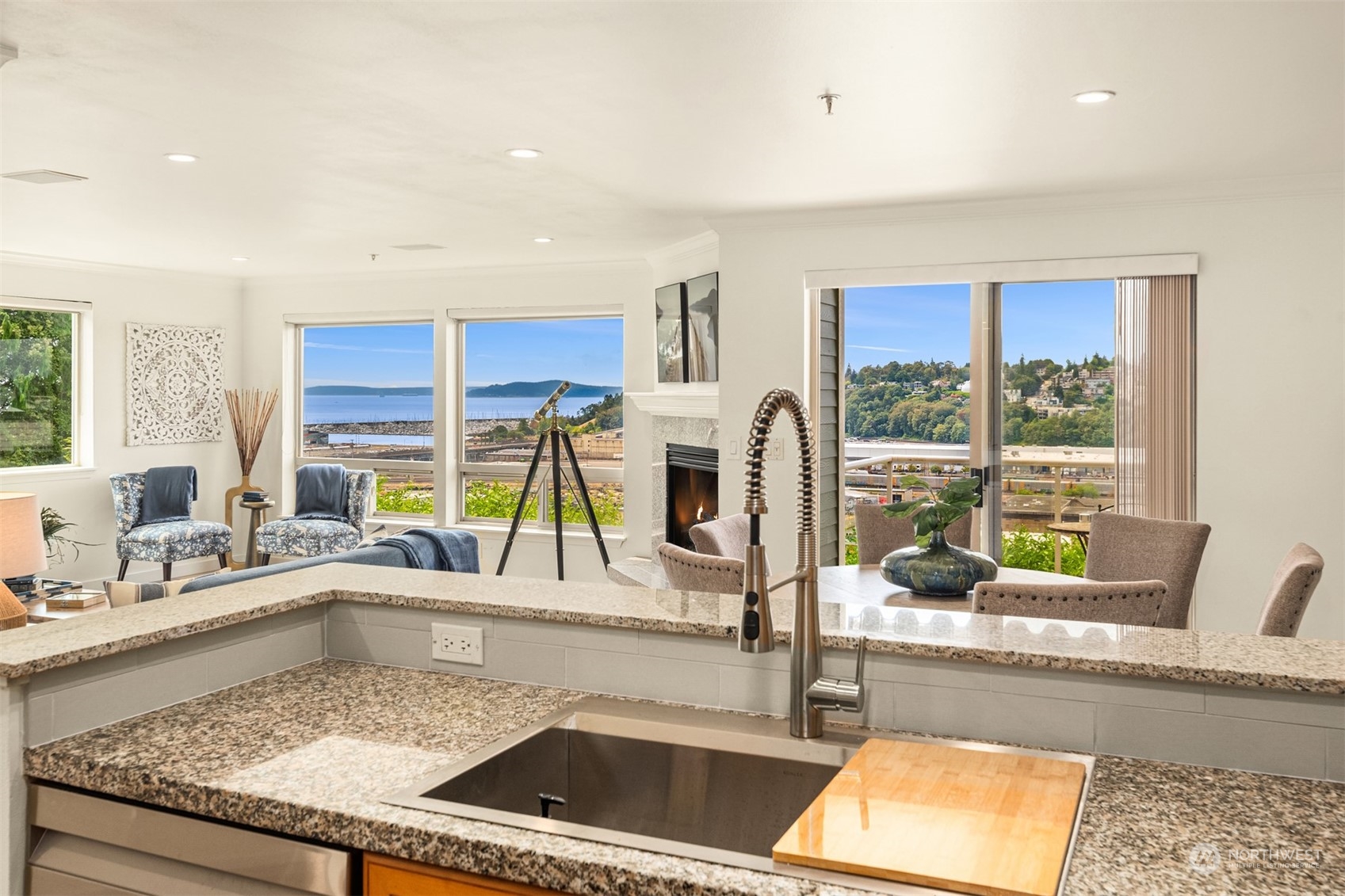 a kitchen with a sink a counter top space and living room filled with furniture