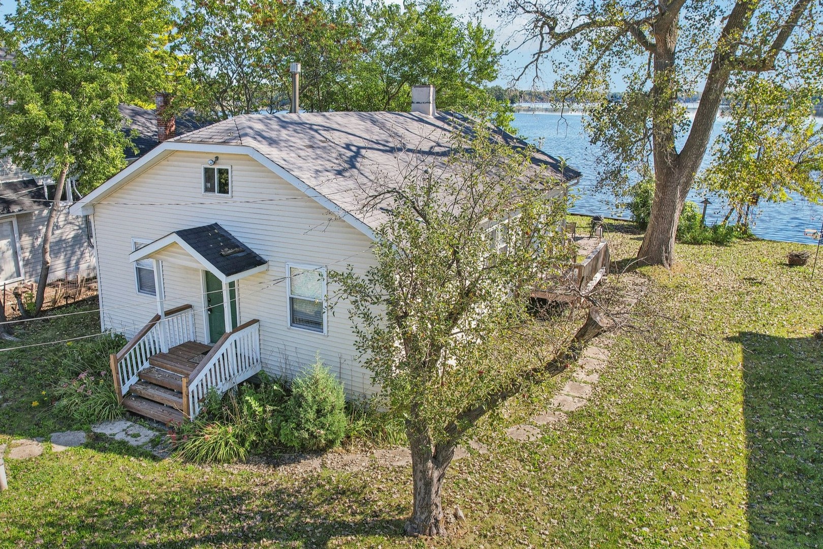 a aerial view of a house with a yard and large trees