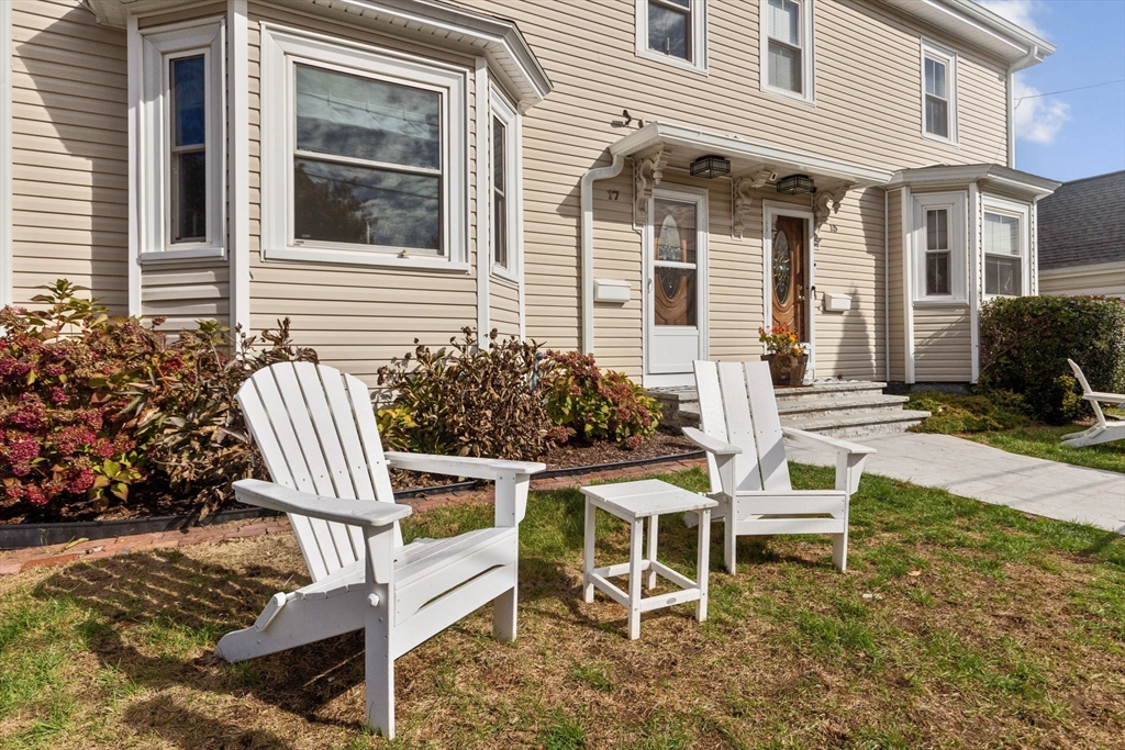 a wooden bench sitting in front of a house