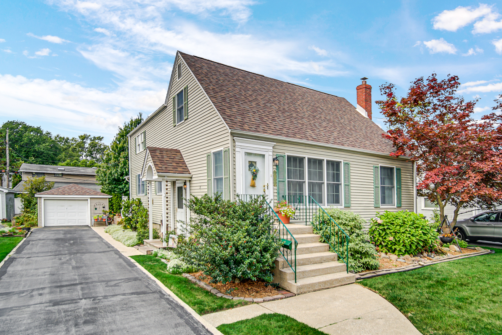 a front view of a house with a yard and a garage