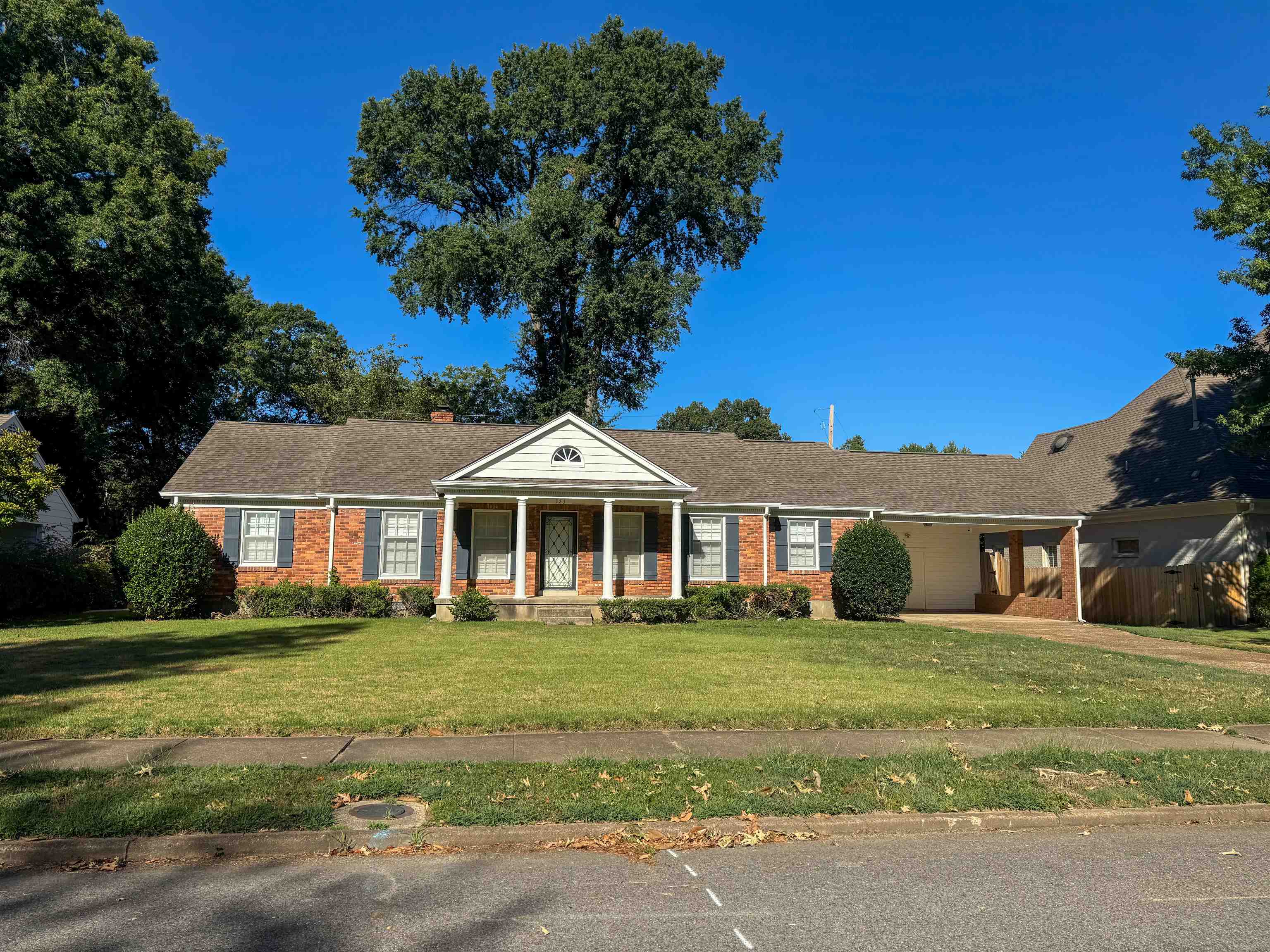 a front view of a house with a garden