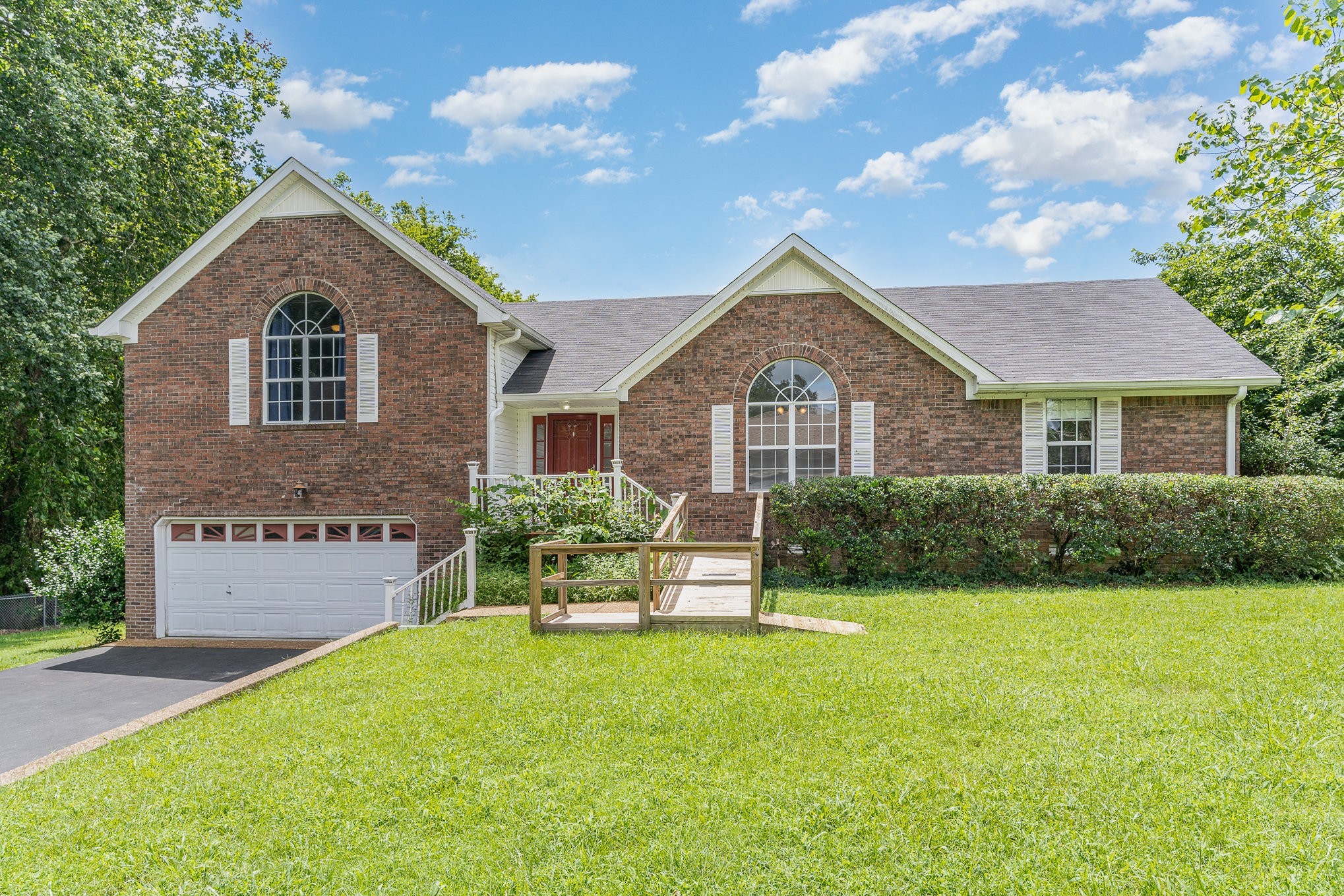 a front view of a house with a yard and garage