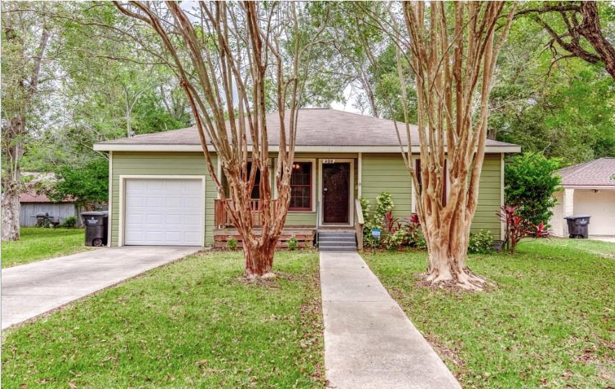 a front view of a house with a yard and porch