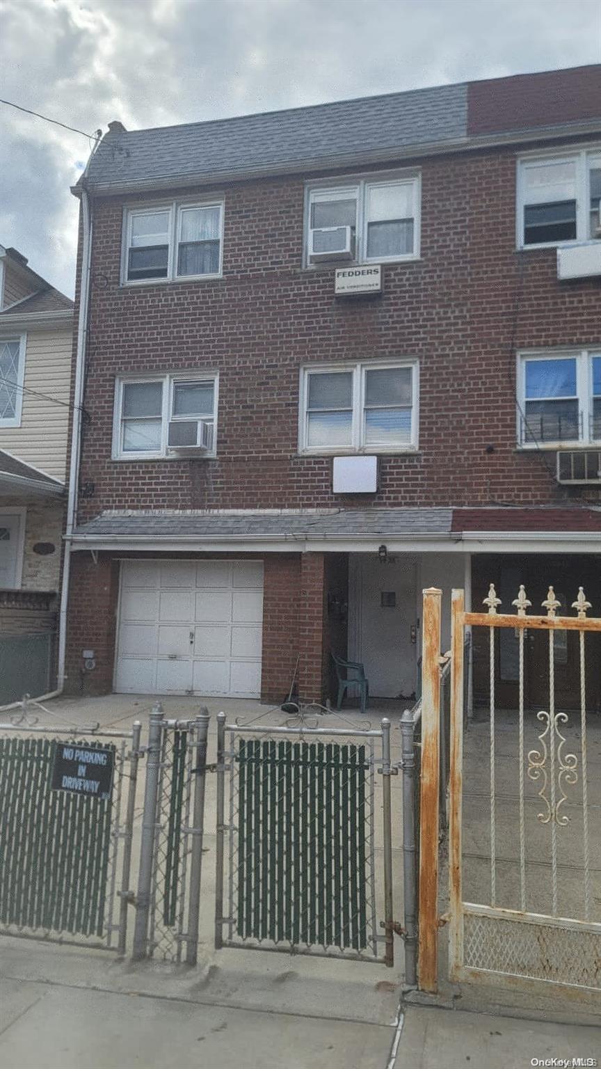 a front view of a house with a fence