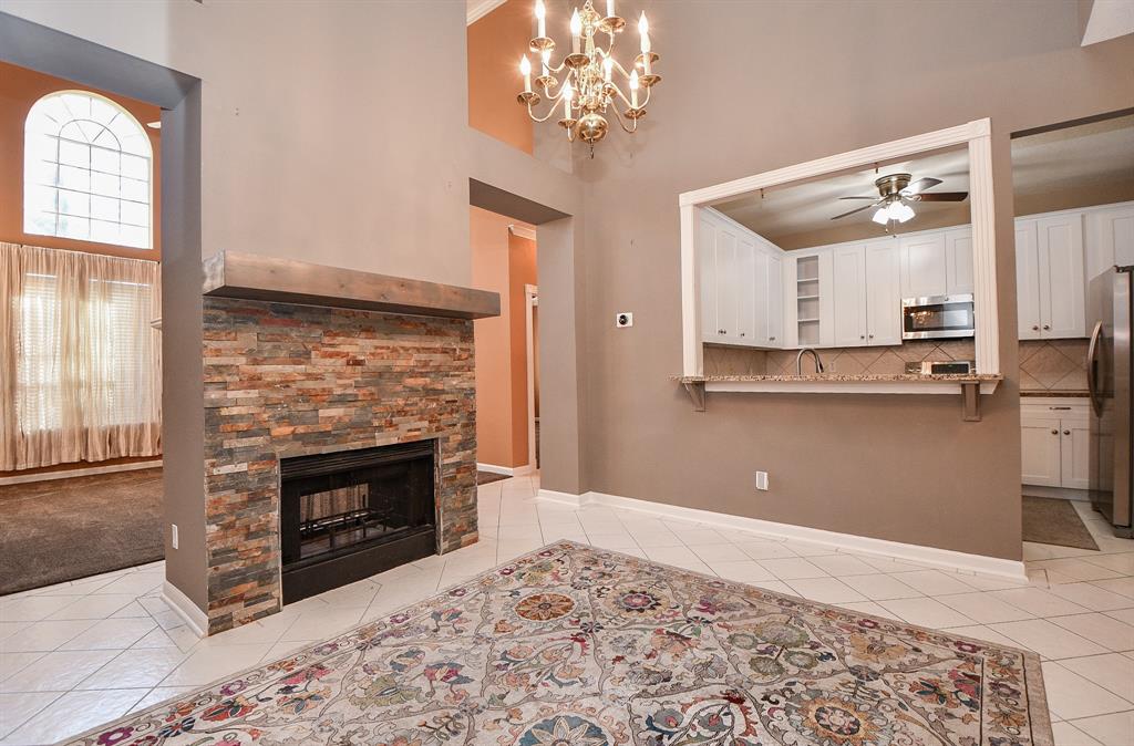 a view of kitchen with granite countertop stove top oven and cabinets