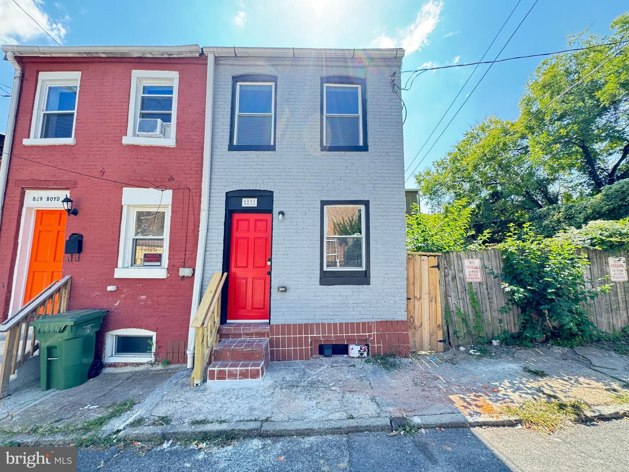 a view of brick house with a yard