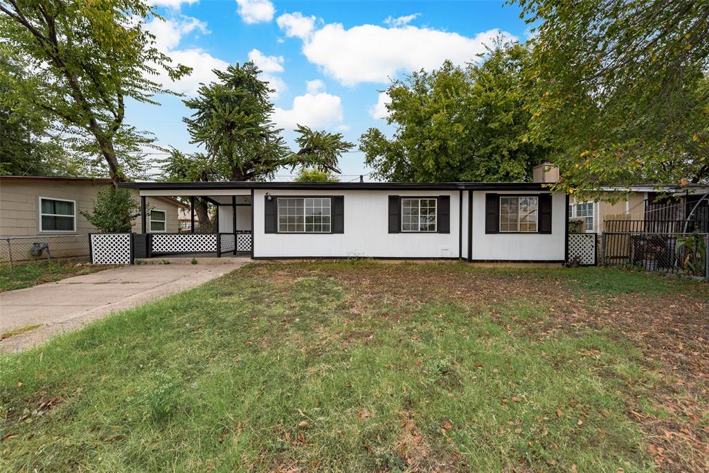 front view of house with a yard and trees