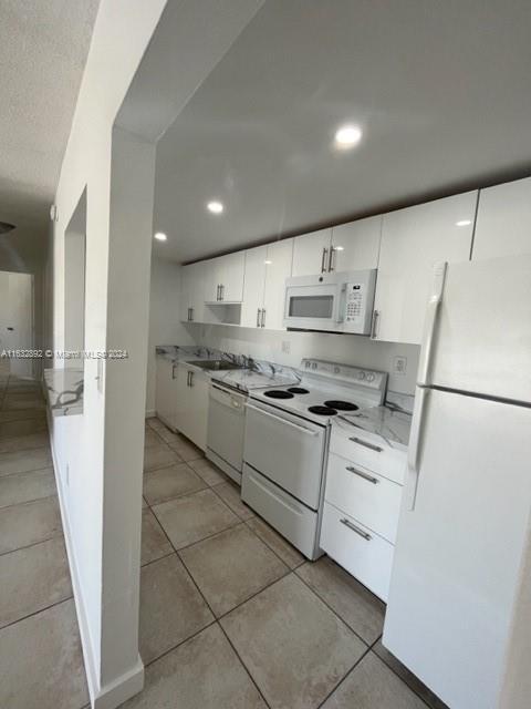 a kitchen with stainless steel appliances a refrigerator sink and cabinets