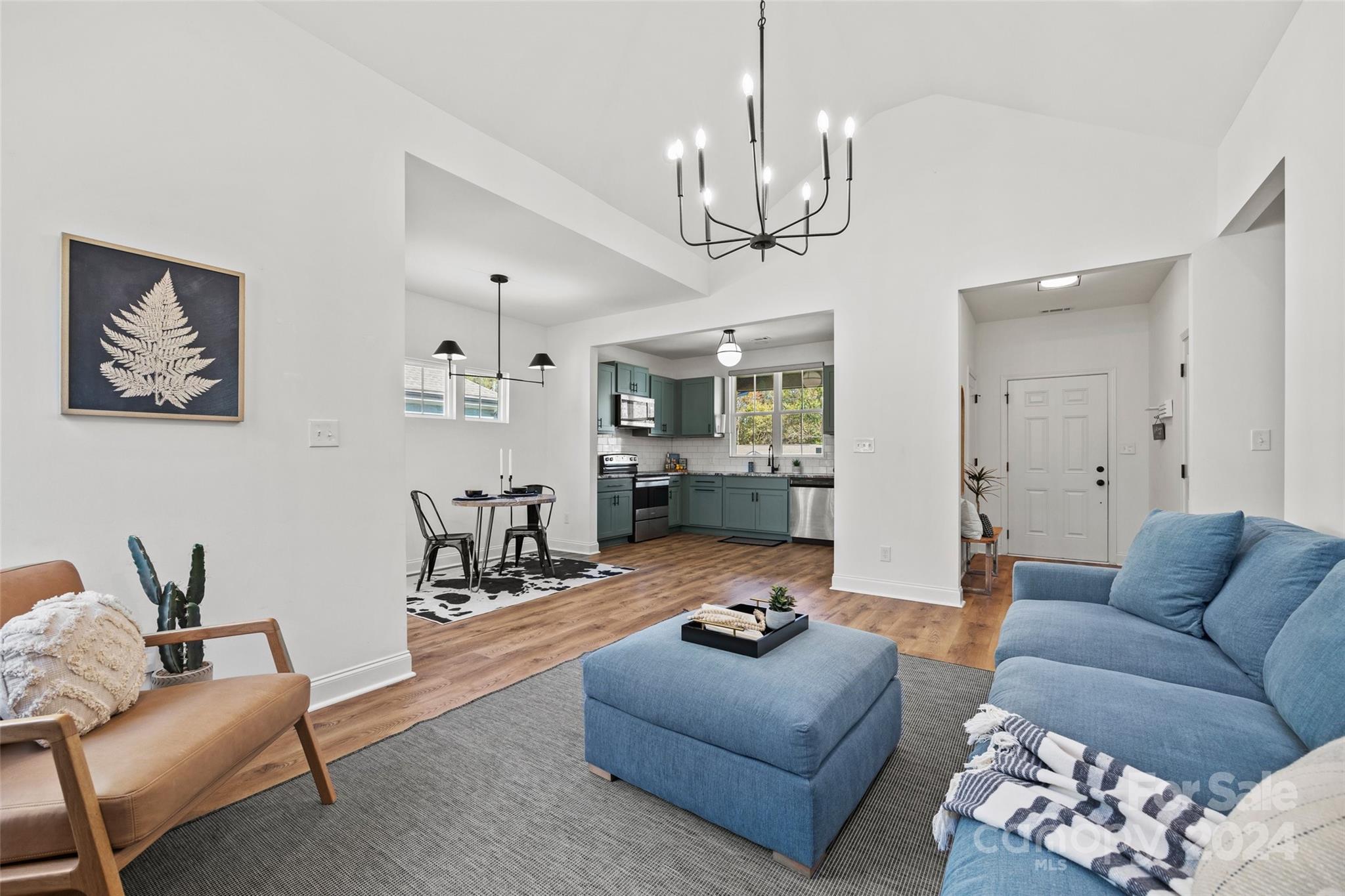 a living room with furniture or couch and a chandelier