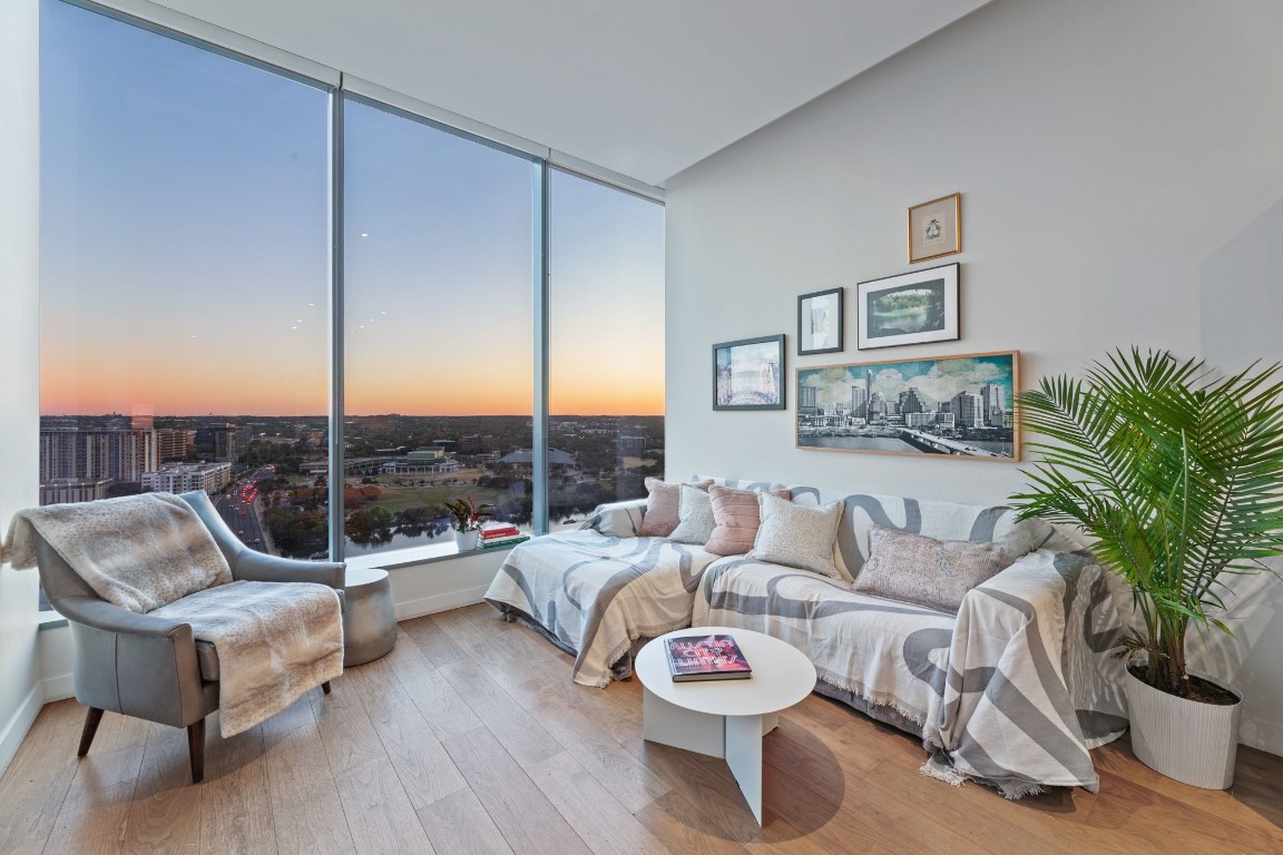 a living room with furniture and a wooden floor