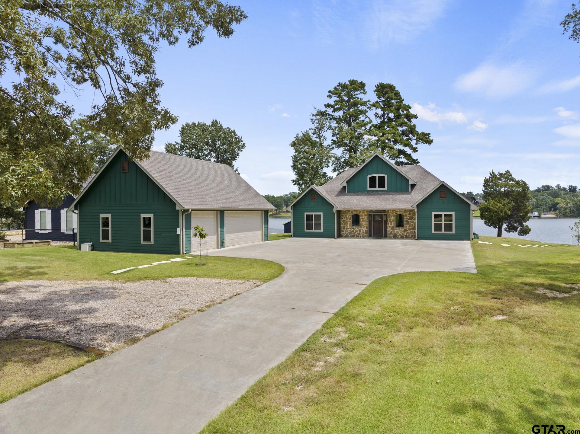 a view of house with outdoor space and swimming pool