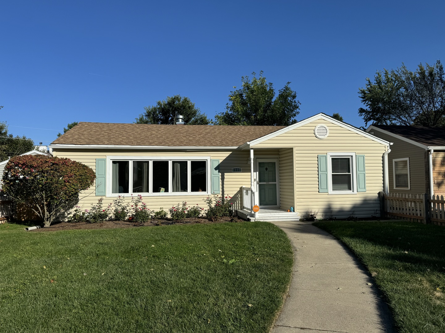 a front view of a house with a garden