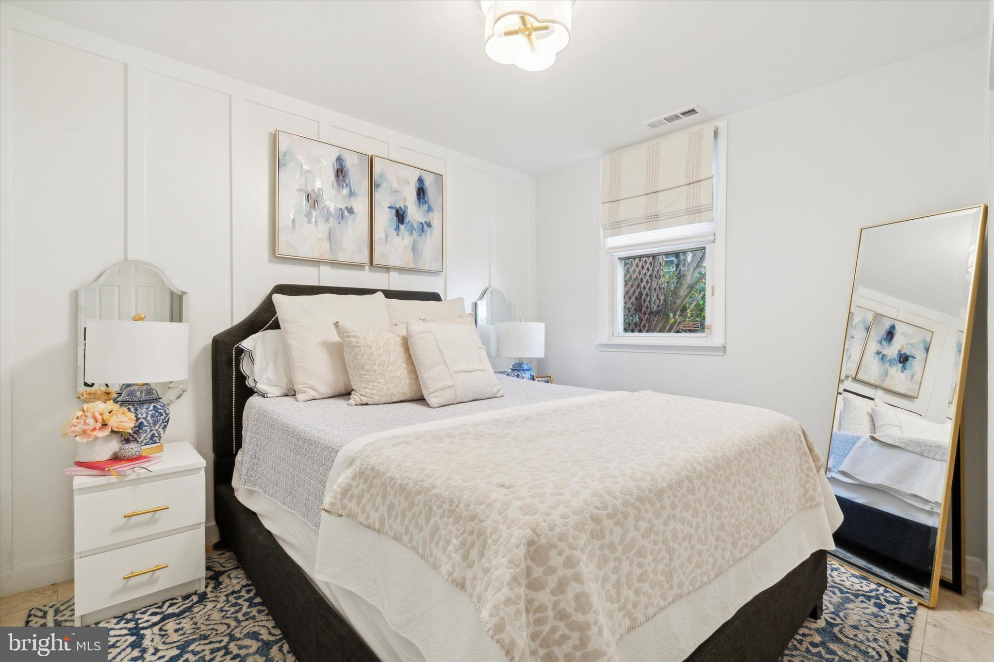 a bedroom with a large bed and a window