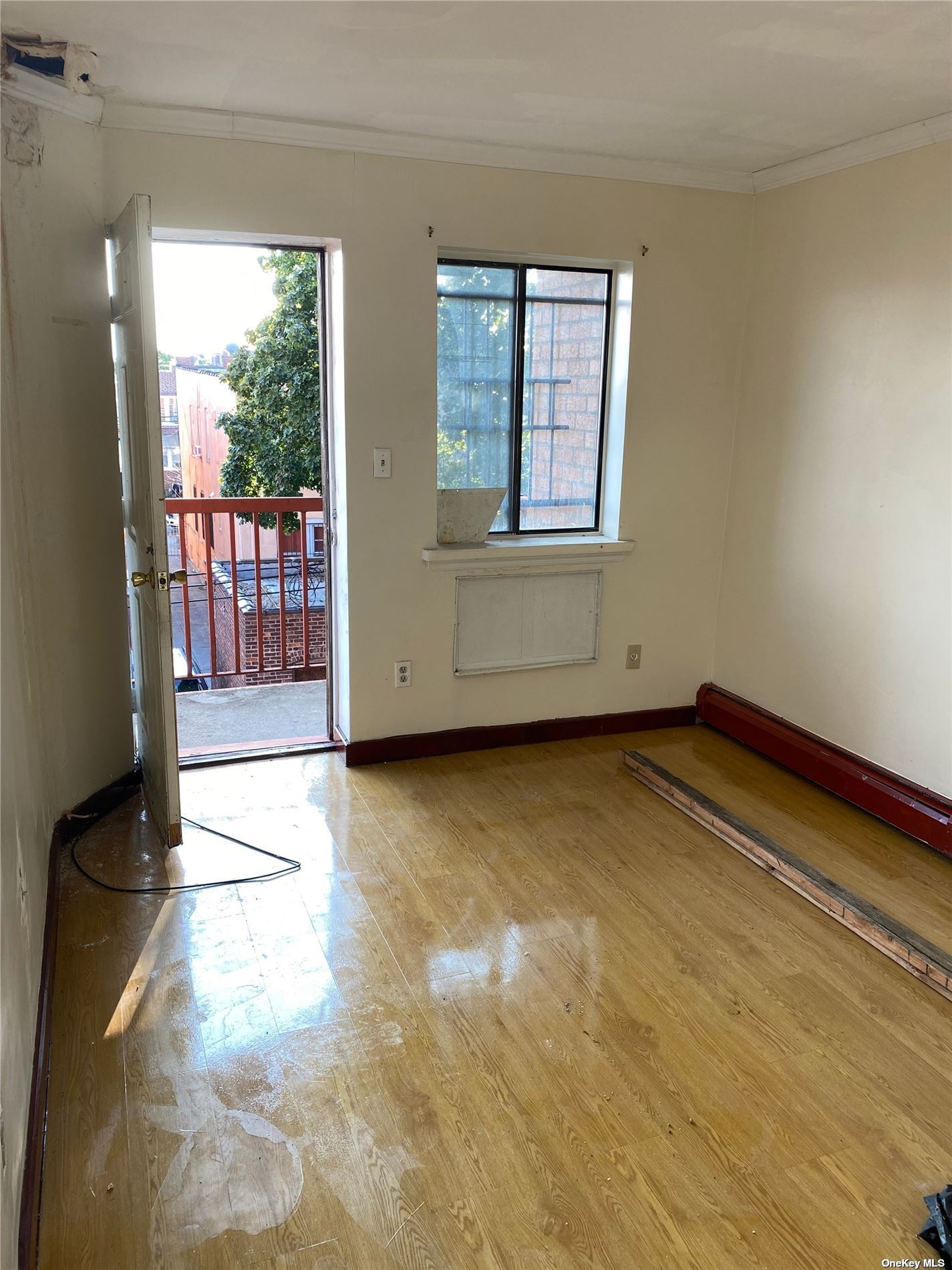 a view of a room with wooden floor and windows