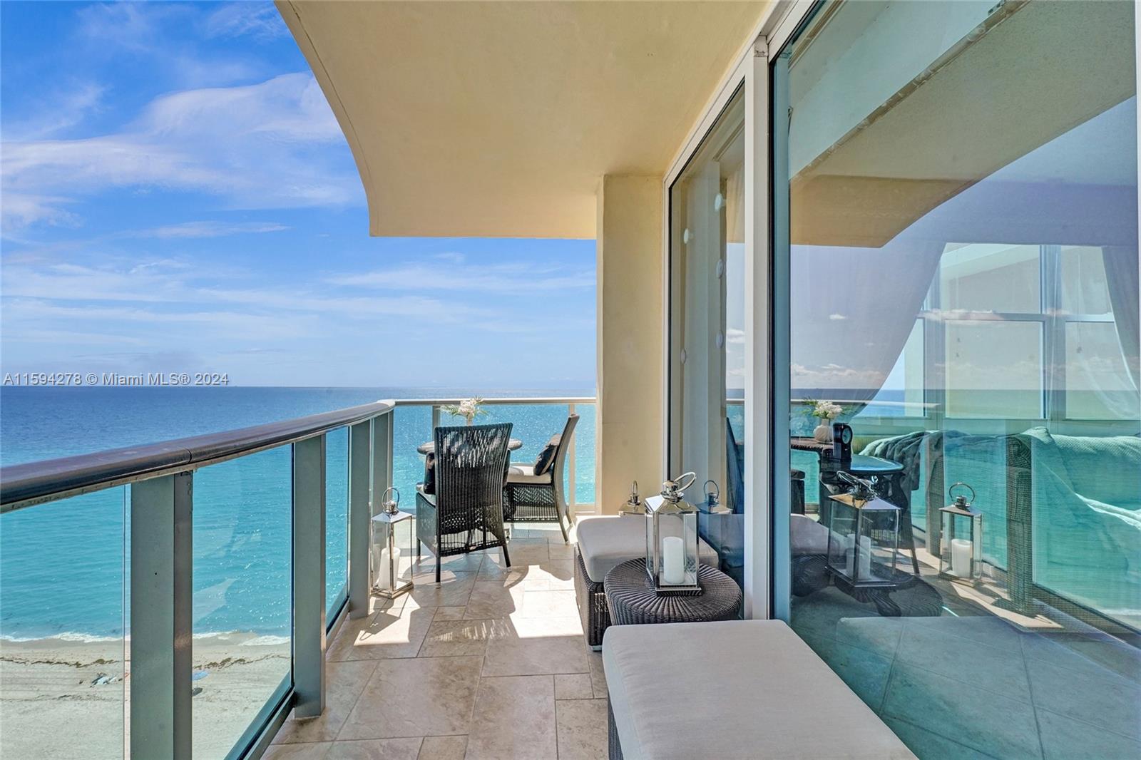 a balcony view with a table and chairs