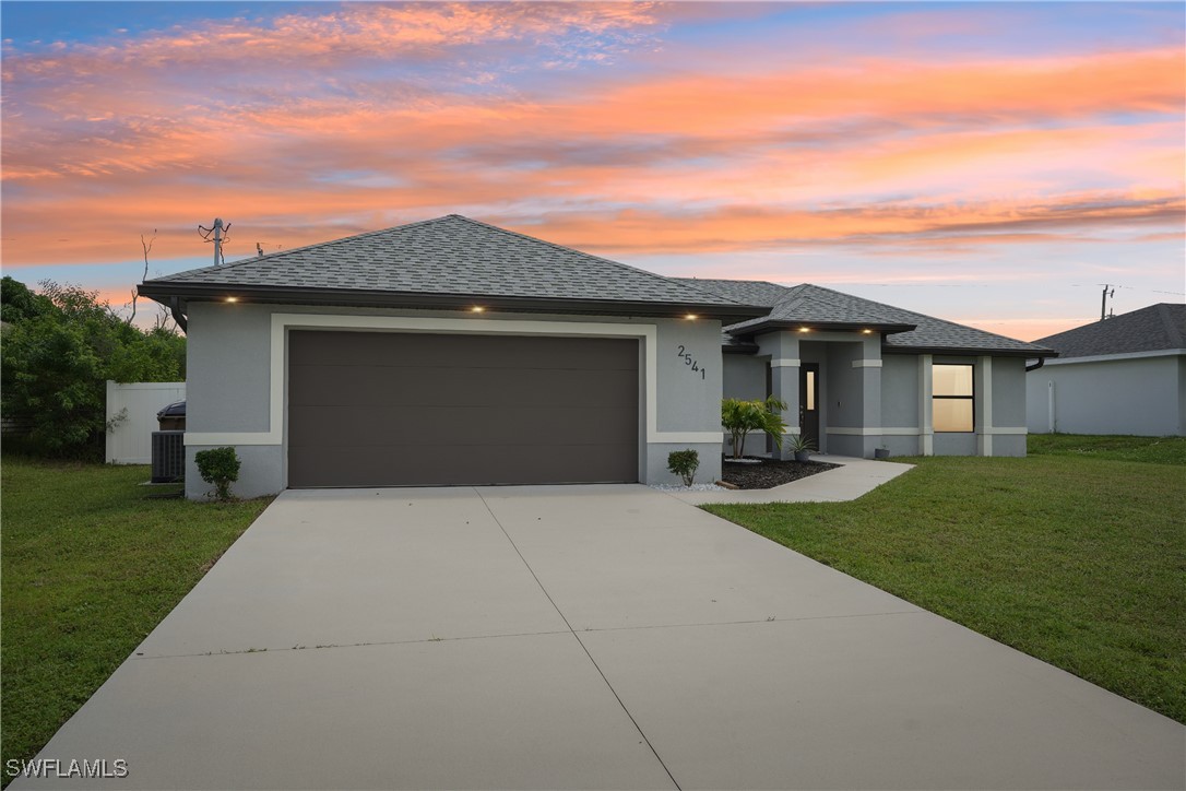 a front view of a house with a yard and garage