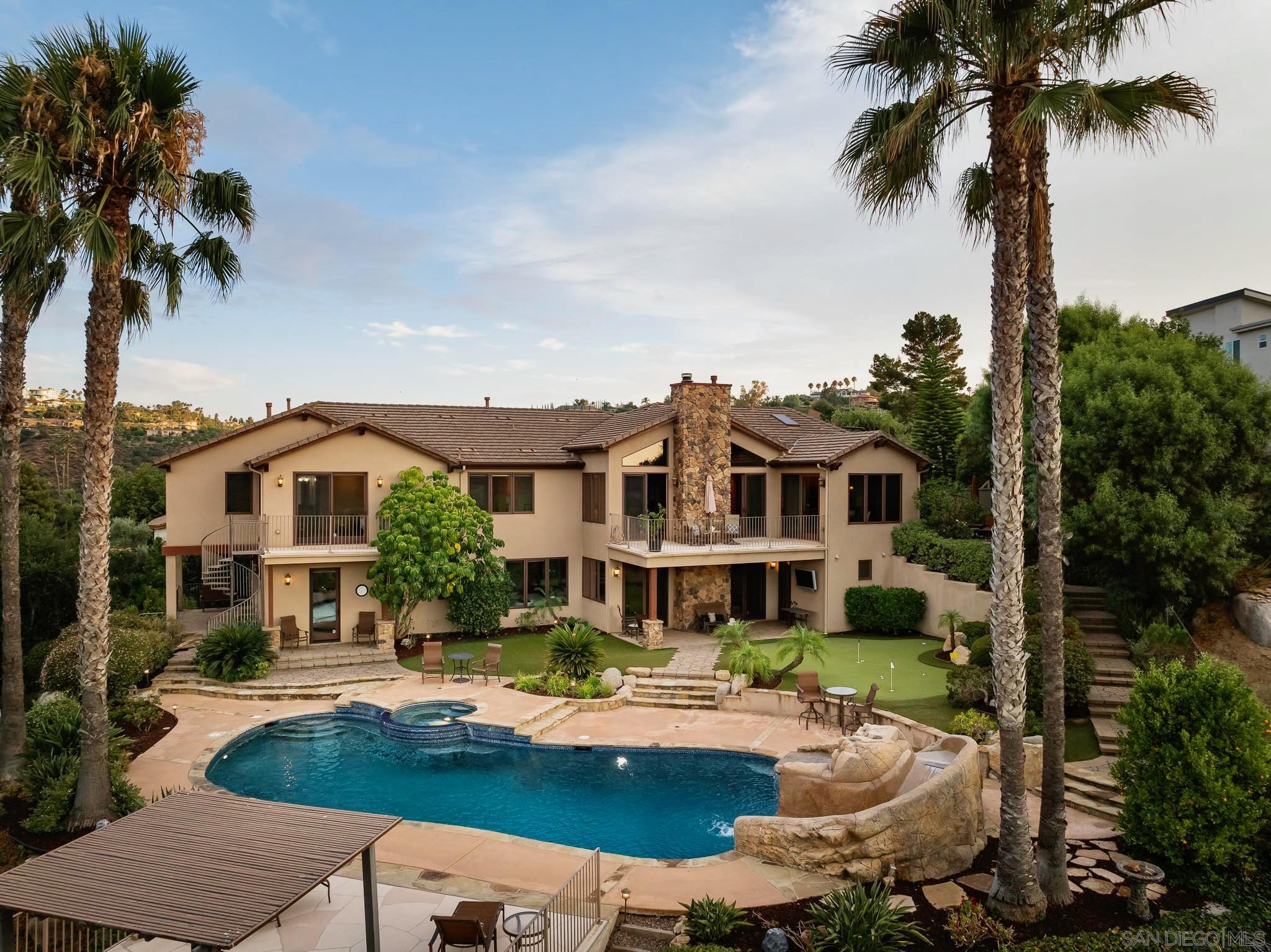 a front view of a house with swimming pool having outdoor seating