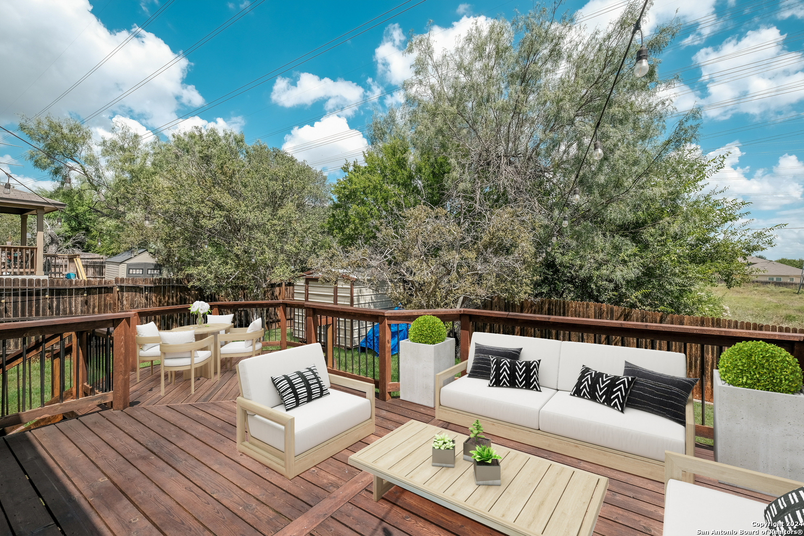 a balcony with wooden floor and outdoor seating