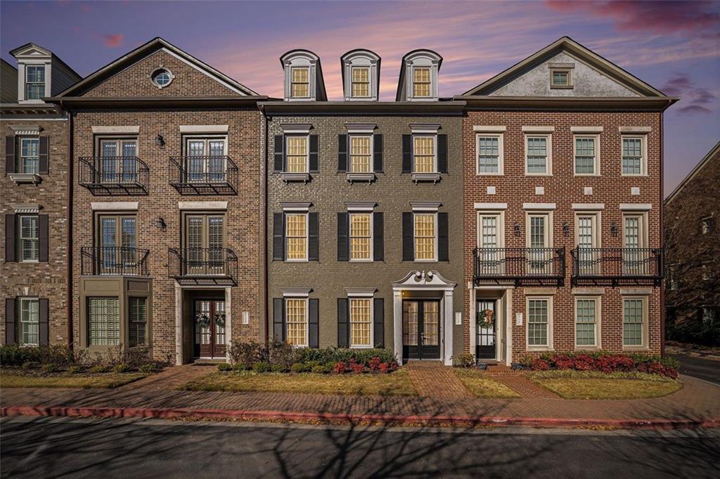 a front view of a residential apartment building with a yard