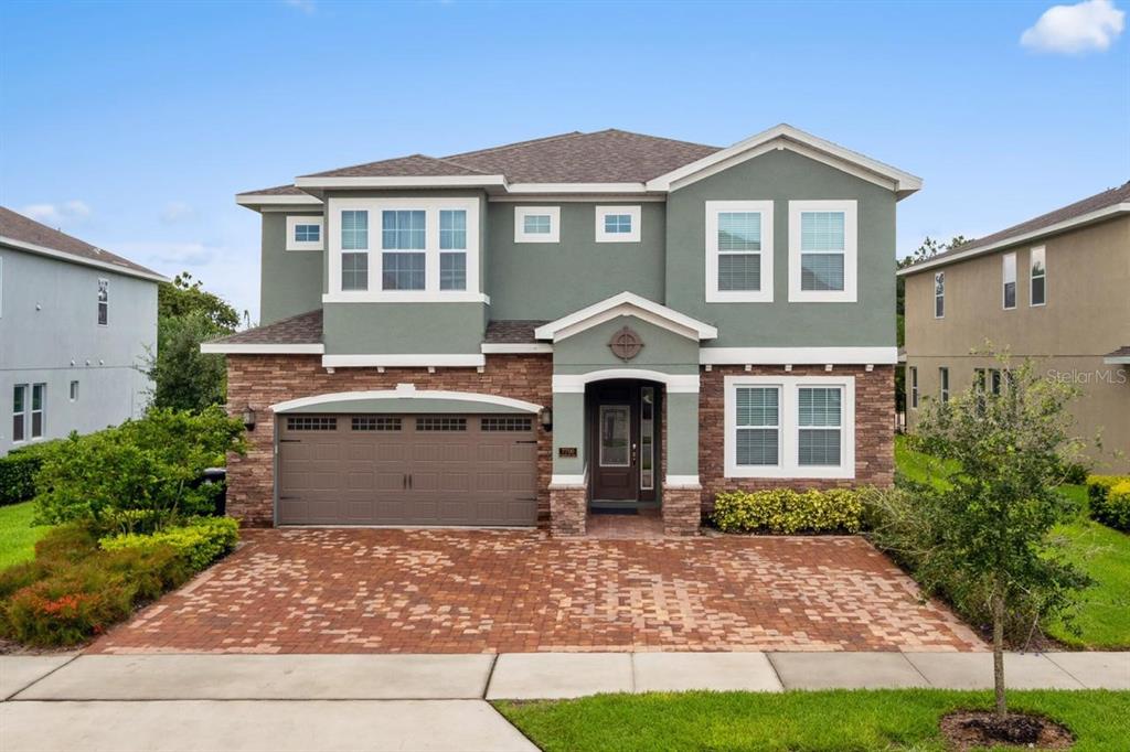 a front view of a house with a yard and garage