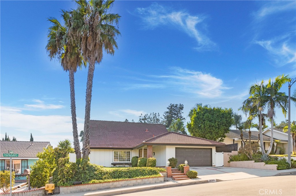 a front view of a house with yard and trees