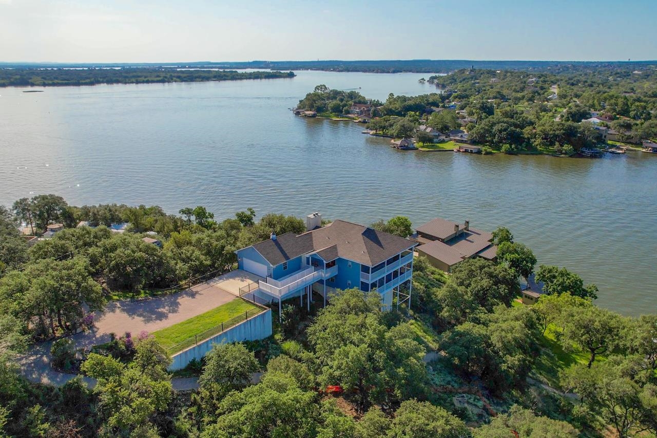 an aerial view of a house with a lake view