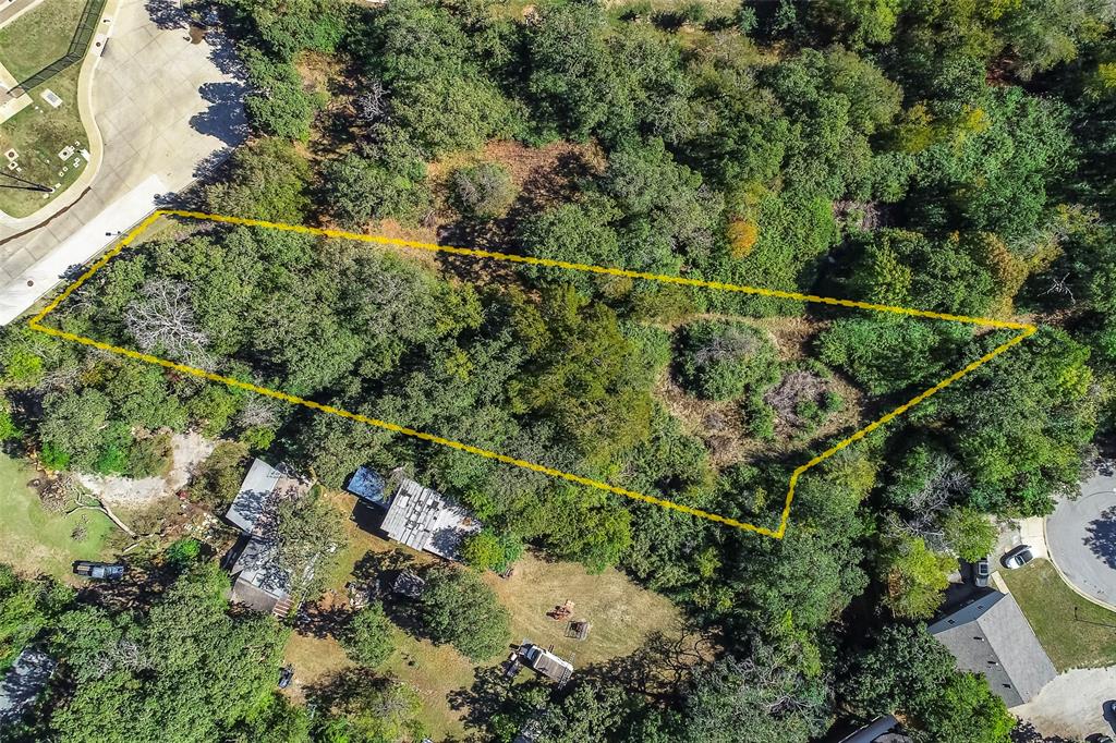 an aerial view of a house with a forest