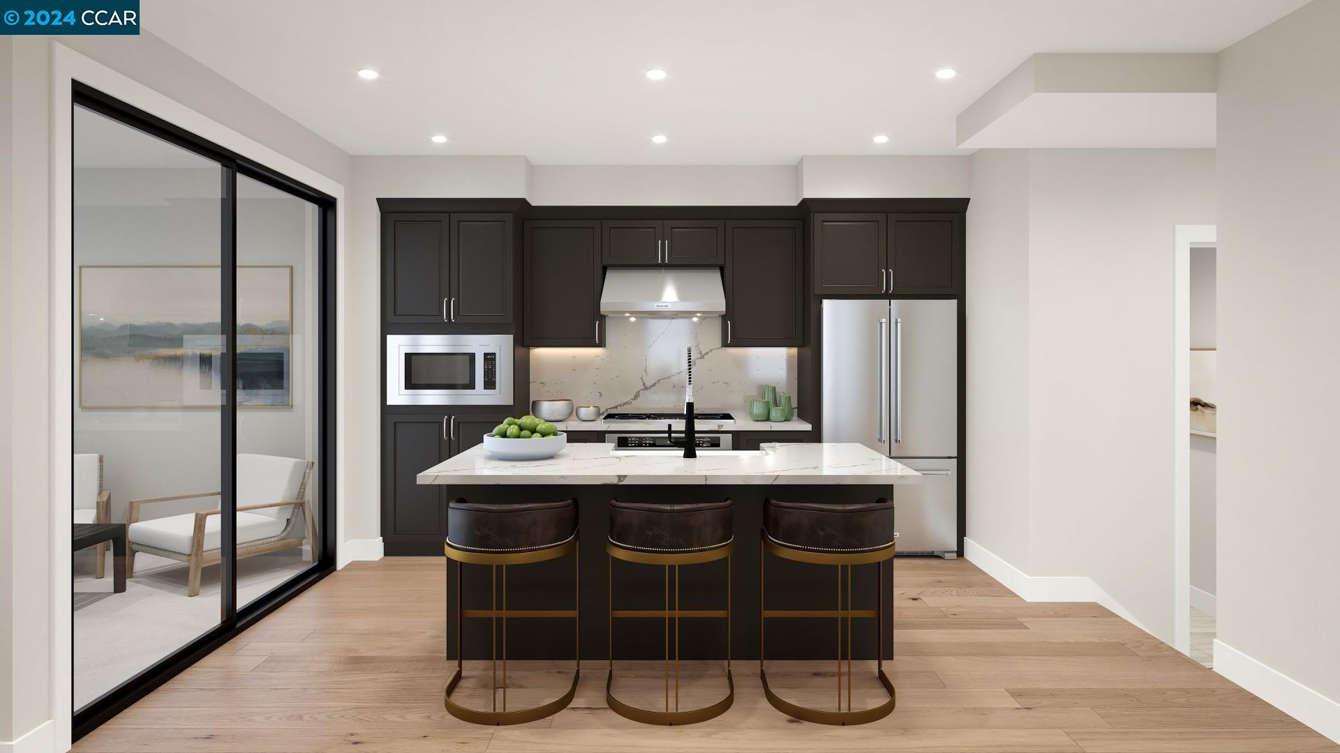 a kitchen with kitchen island stainless steel appliances a sink cabinets and wooden floor