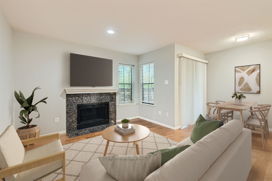 a living room with furniture a fireplace and a flat screen tv