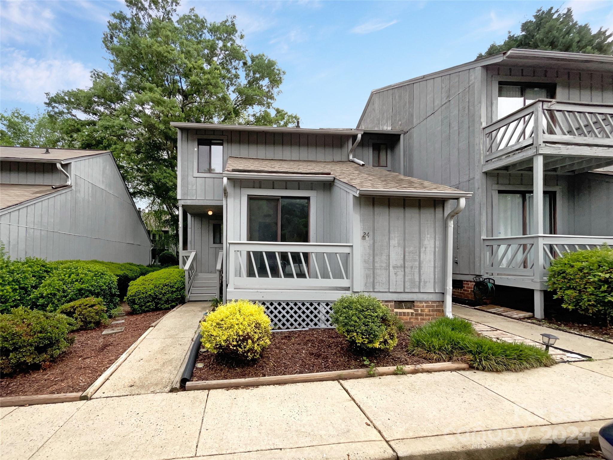 a front view of a house with garden