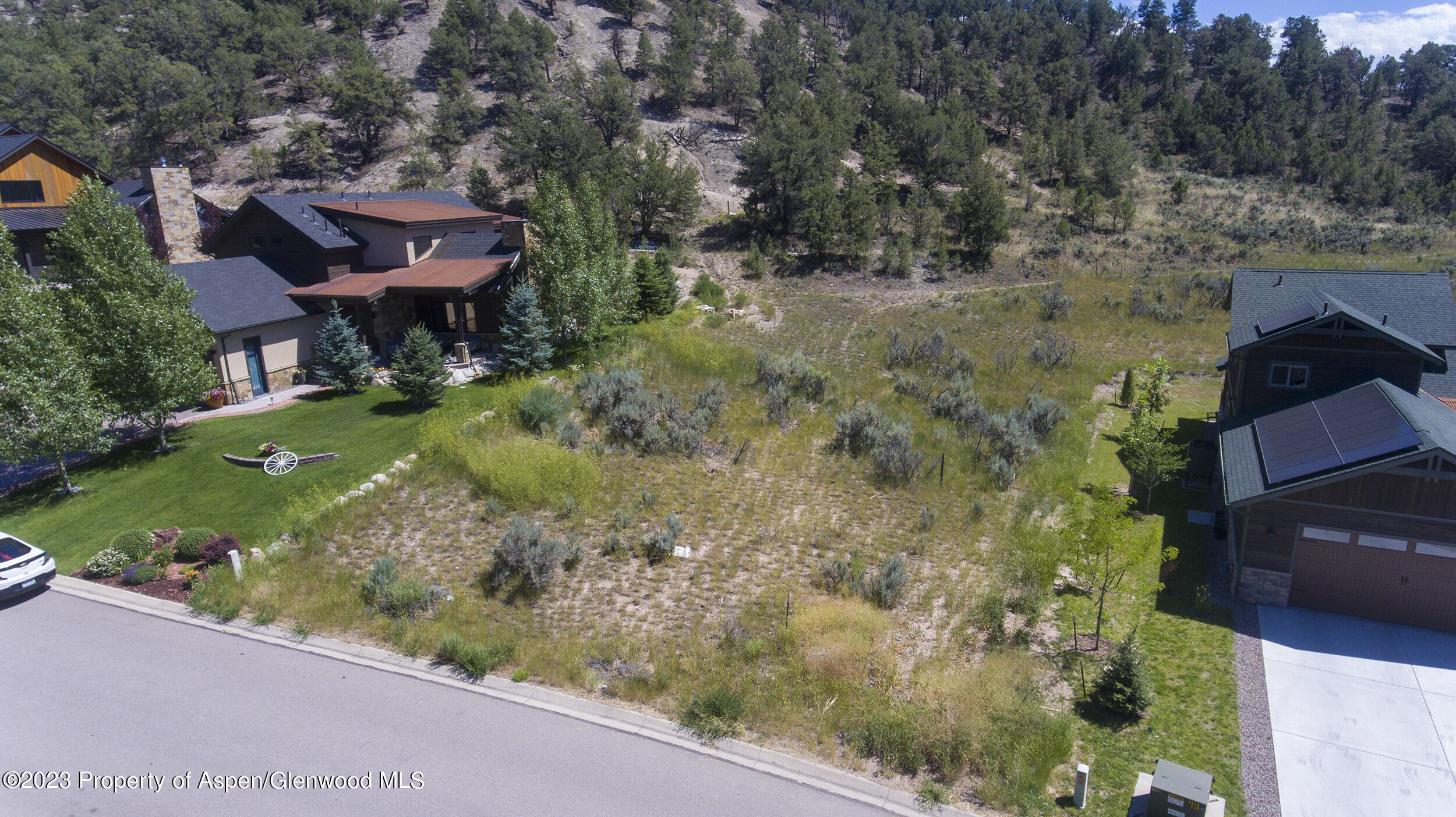 an aerial view of a house with a yard basket ball court and outdoor seating