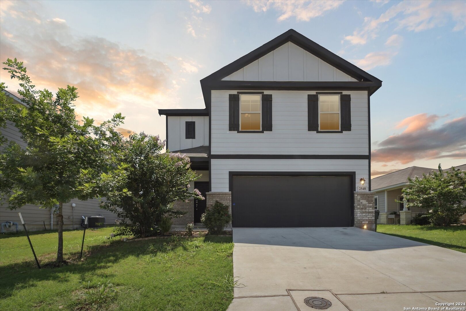 a front view of a house with a yard and garage