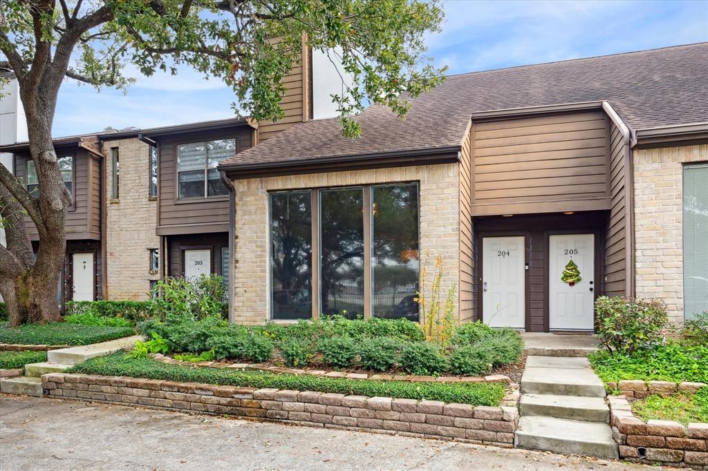 Welcome Home! This charming townhouse features a two-story design with a mix of brick and wood siding. It has large front windows and well-maintained landscaping, creating a welcoming entrance. Perfect for buyers seeking a cozy and stylish home.