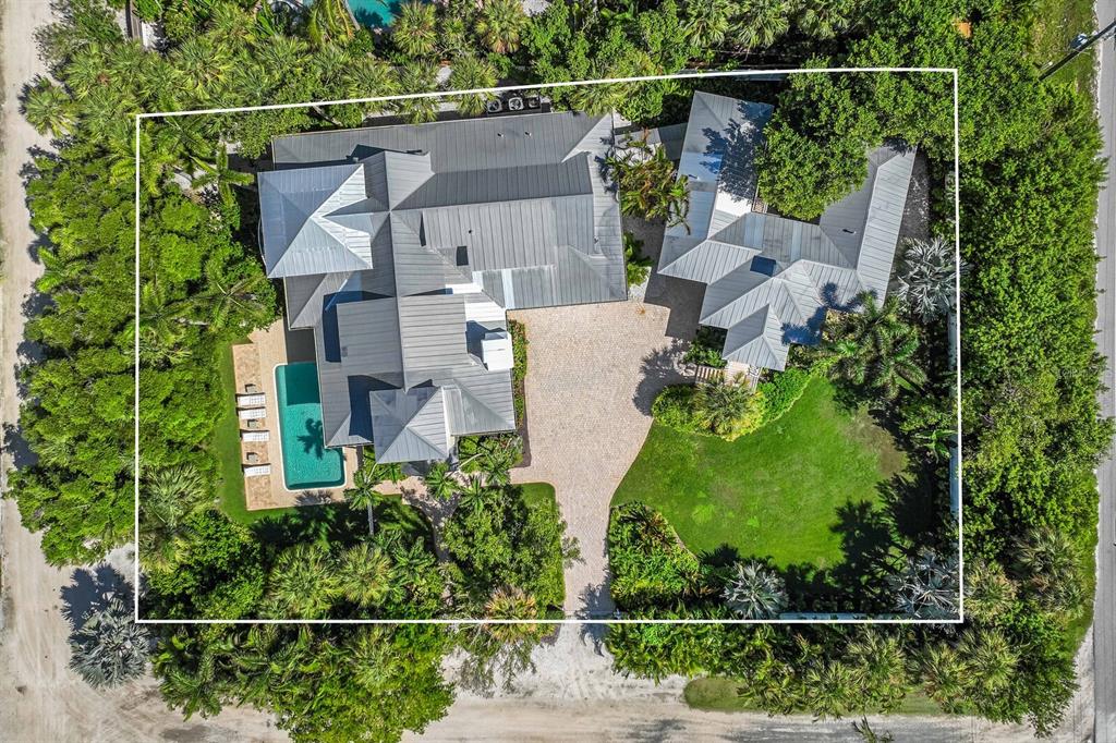 an aerial view of residential house with outdoor space and swimming pool