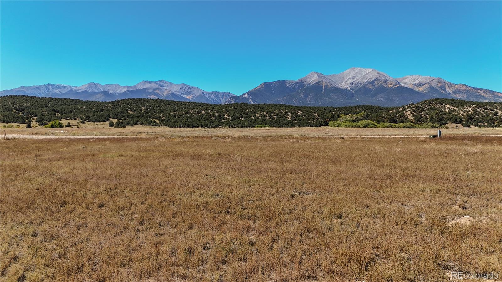 a view of a large body of water with mountain in the background