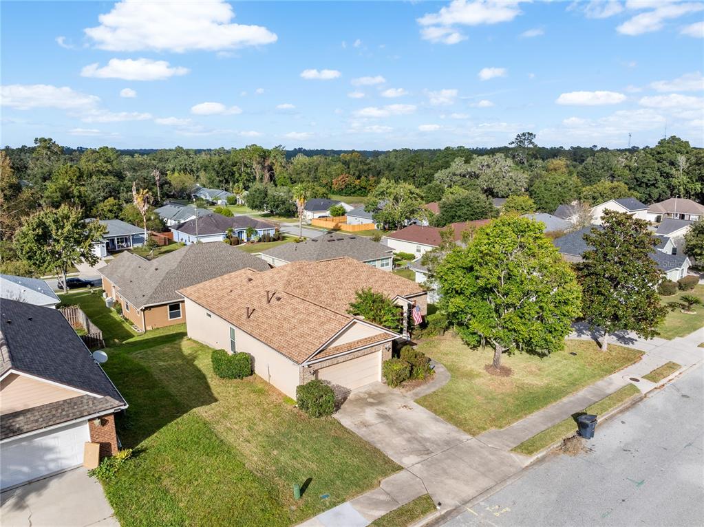 an aerial view of a house with a yard and lake view