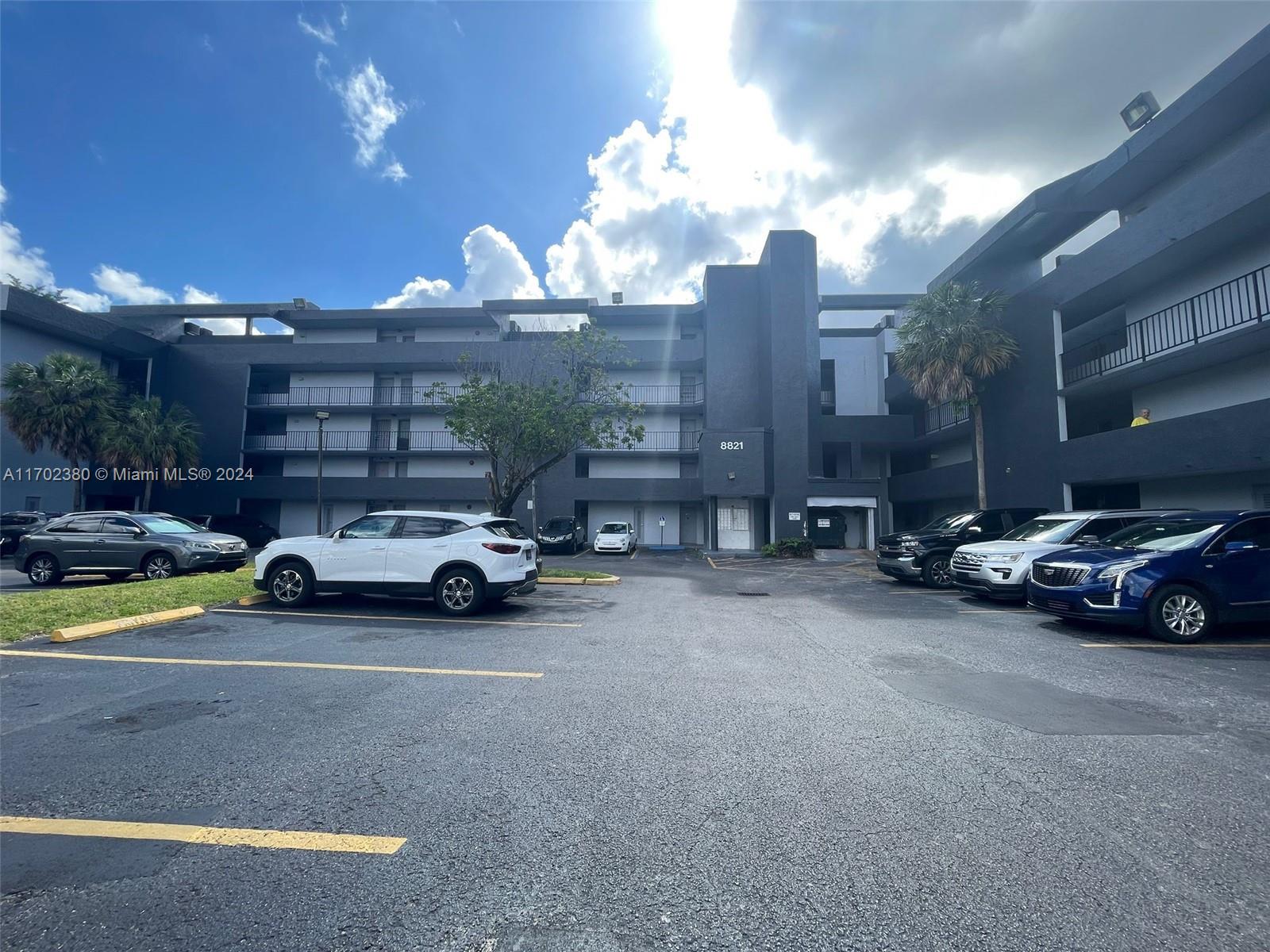 a view of parking with cars parked