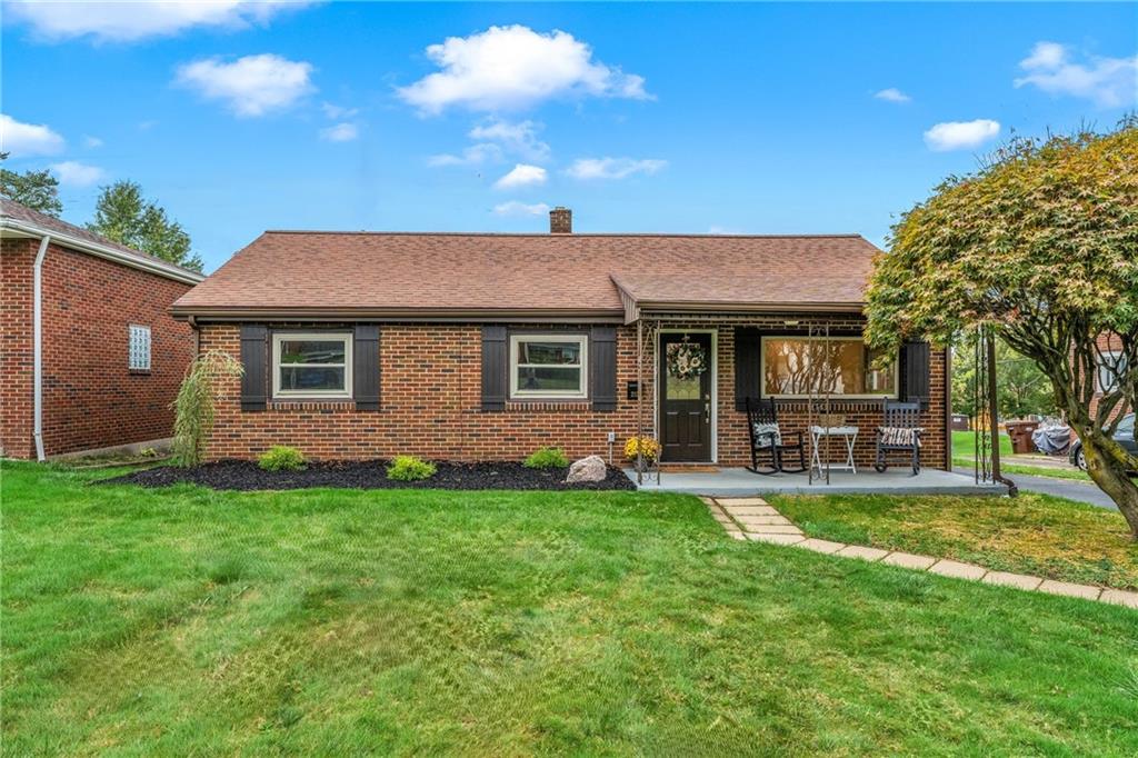 a front view of a house with a garden and patio