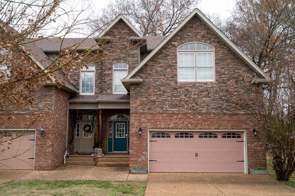 a front view of a house with garage