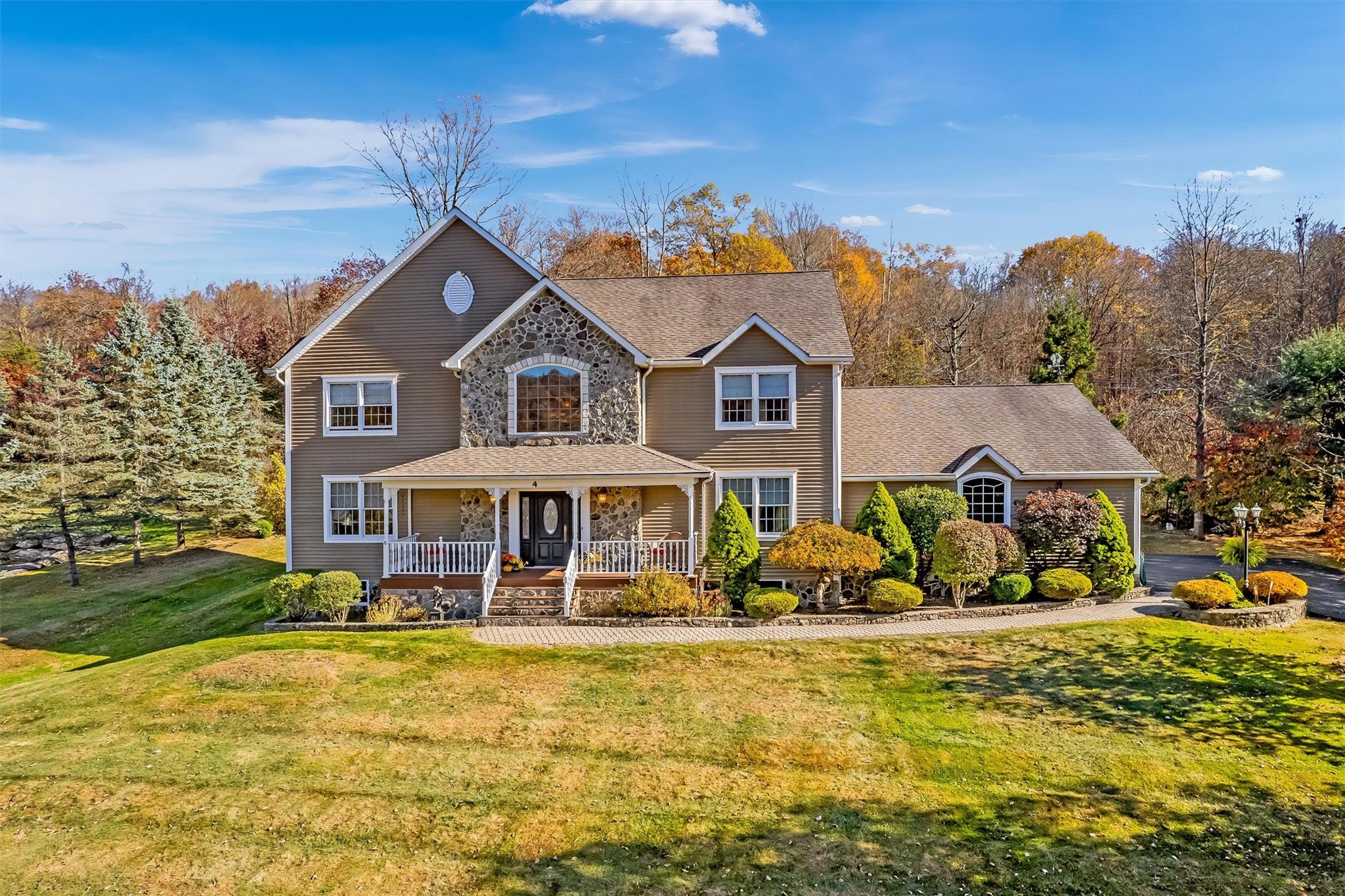 Front of property with covered porch and a front yard