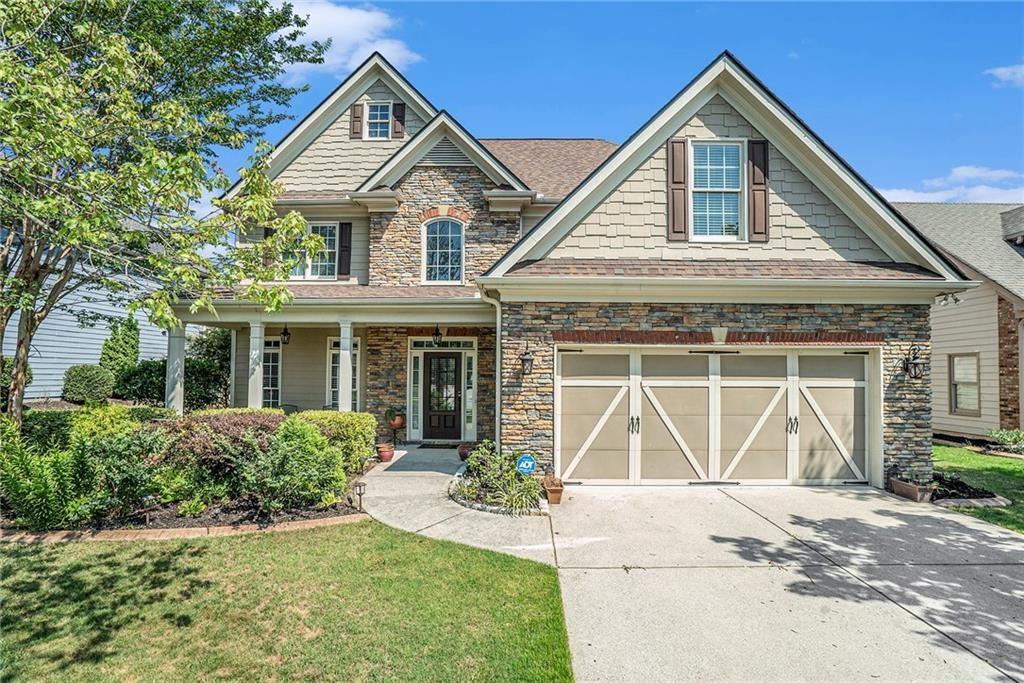 a front view of a house with a yard and garage