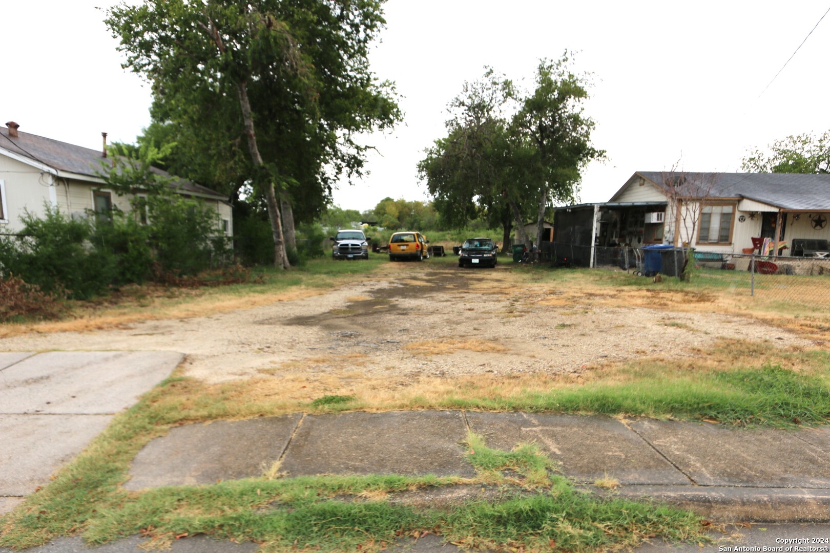 a backyard of a house with yard and tree