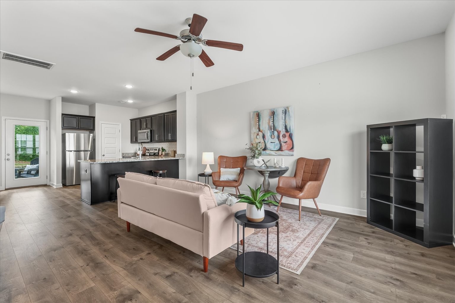 a living room with furniture a window and kitchen view